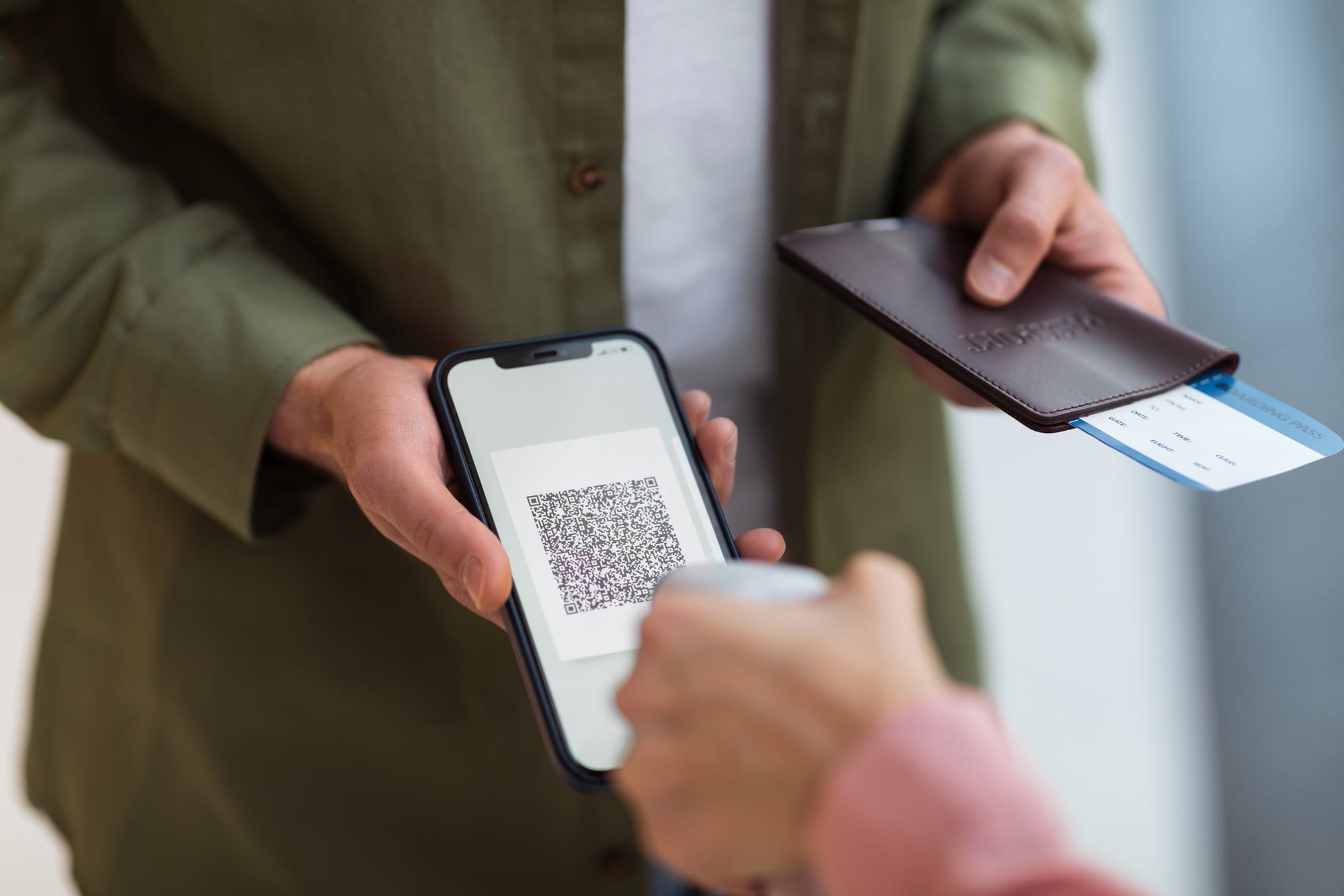 Unrecognizable Man Showing Vaccination Certificate On Phone Standing Indoor